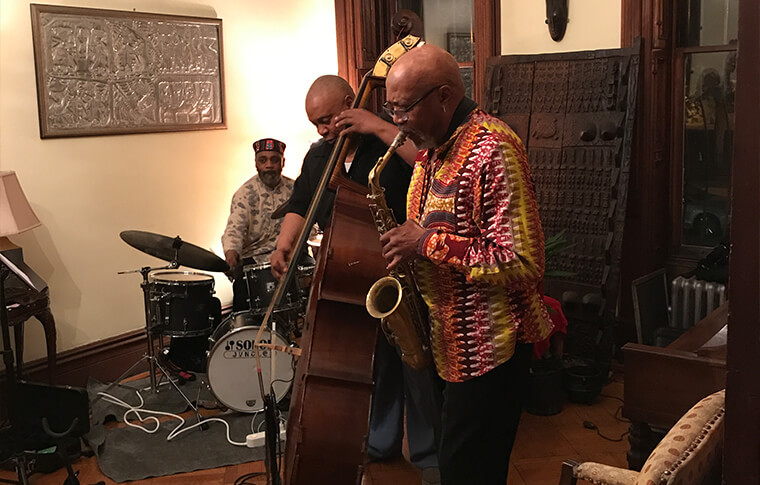 3 musicians jamming together in the intimate venue of Welcome to Harlem's Brownstone location