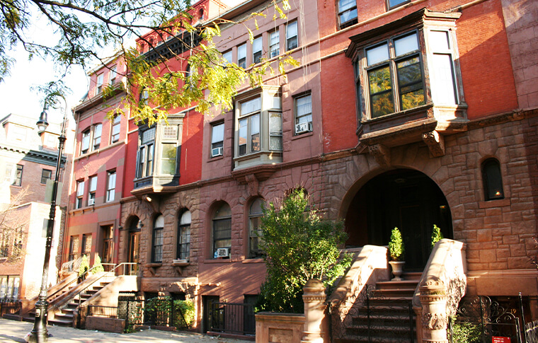 Mount Morris Park Harlem Brownstone buildings on a sunny day